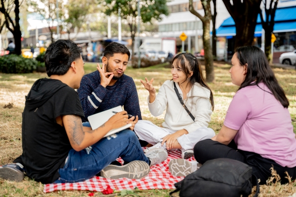 Deaf students communicating in sign language on the public park